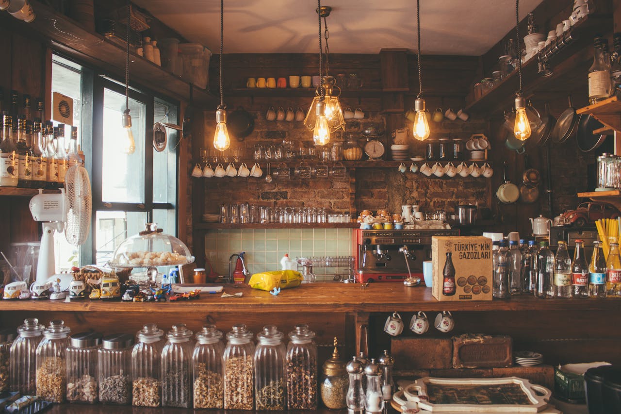 A cozy cafe with rustic decor, pendant lights, and glass jars creates a vintage ambiance.